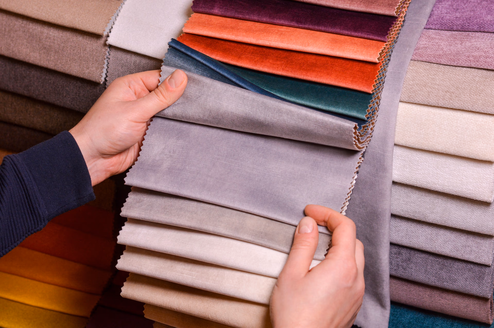 Shadify consultant measuring a window and presenting curtain fabric samples in a Singapore home