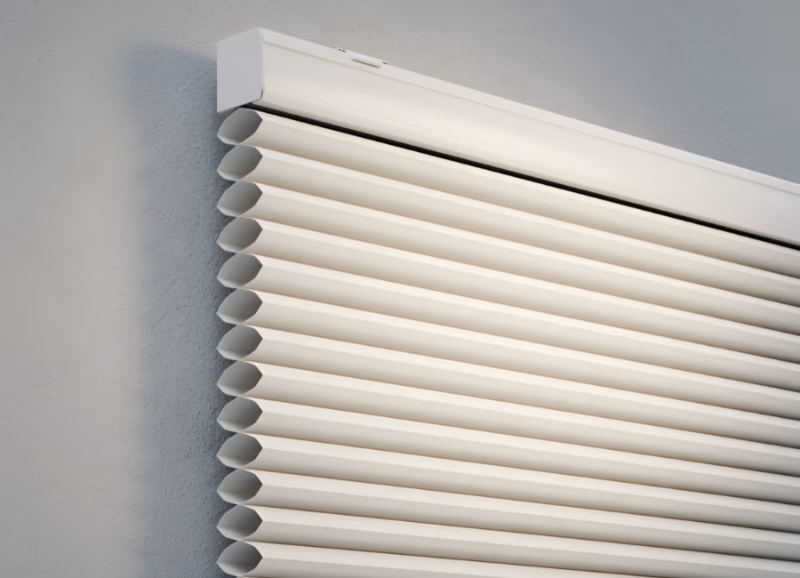 Close-up of a cream honeycomb blind showing its cellular pleat structure