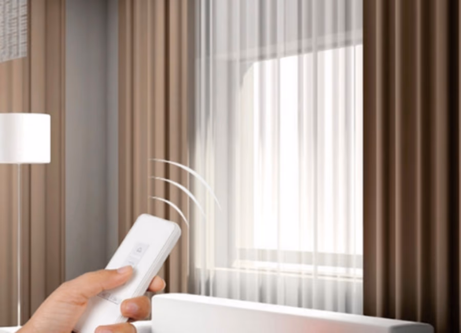 Hand using a remote to close motorised curtains in a Singapore living room
