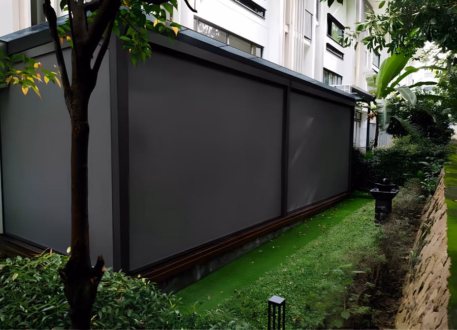 Charcoal outdoor zip blinds enclosing a Singapore condominium garden patio