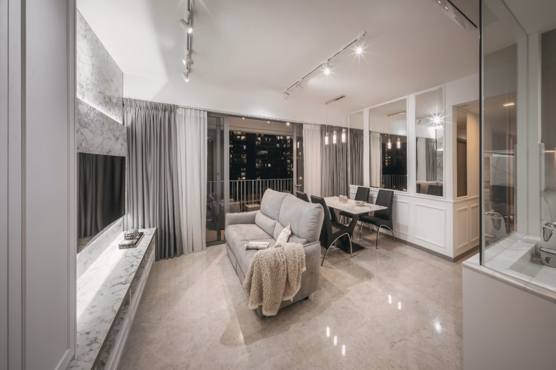 Tie-back patterned night curtains opening onto a balcony in a Singapore condominium