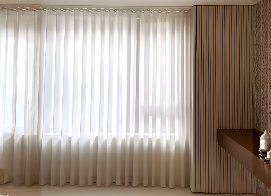 Sheer white ripple S-fold curtains drawn across a wide window beside a timber slat wall in a Singapore home
