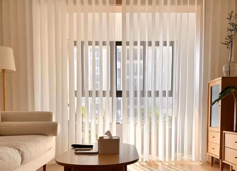 Sheer uni-slat vertical blinds across a bright Singapore living room window